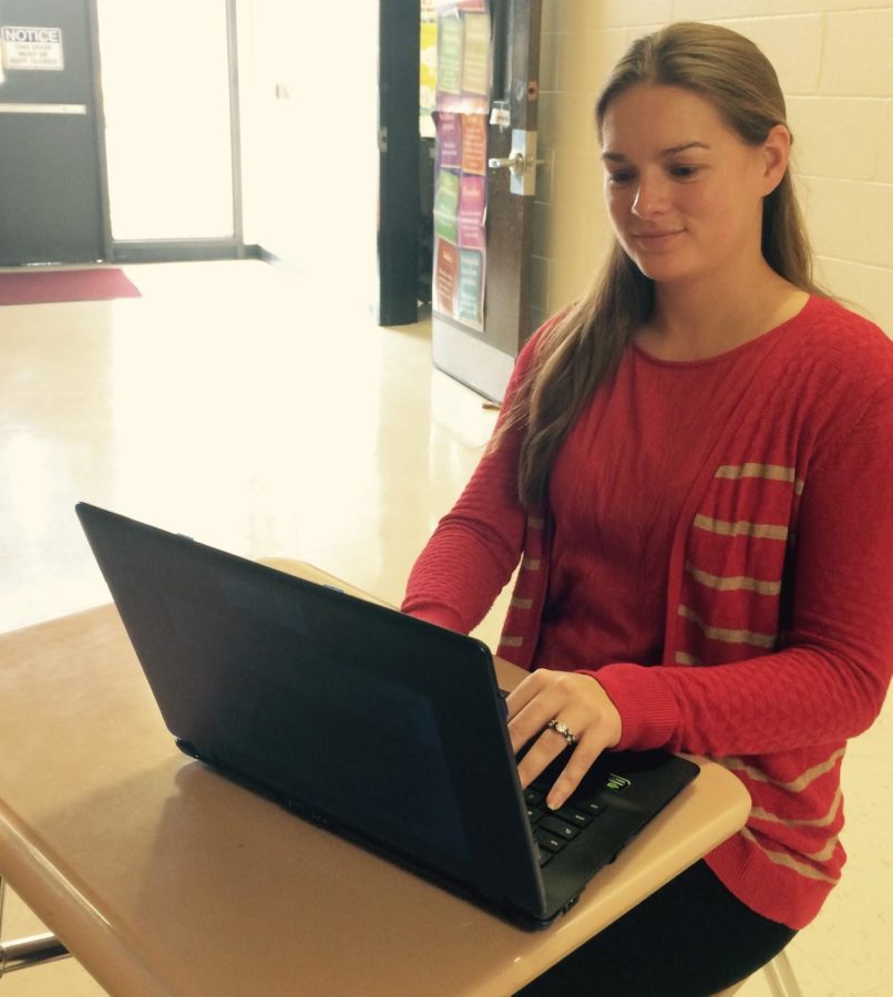 Mrs. Jennifer Norato typing on her Chromebook before teaching one of her seventh grade classes.