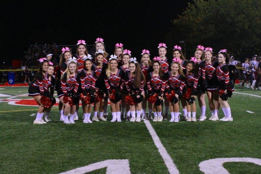 The+varsity+cheer+team+poses+on+the+turf+at+Emerson%27s+homecoming+game+on+October+21%2C+2016.+A+handful+of+the+team+will+soon+begin+the+transition+to+competition+cheer.+