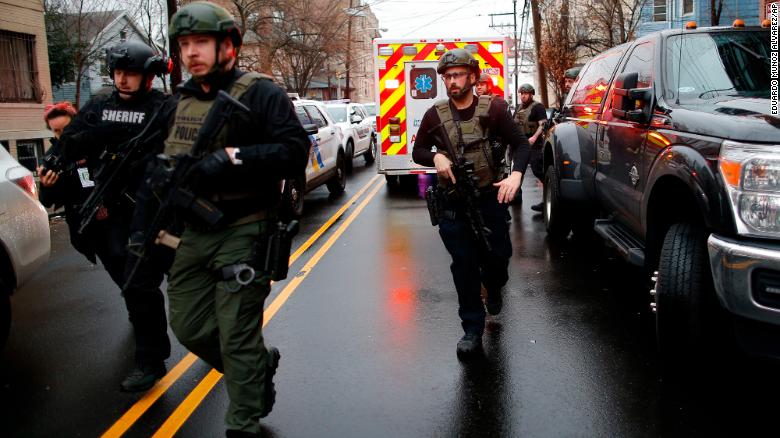 Police officers arrive at the scene following reports of gunfire, Tuesday, Dec. 10, 2019, in Jersey City, N.J.  AP Photo/Eduardo Munoz Alvarez)