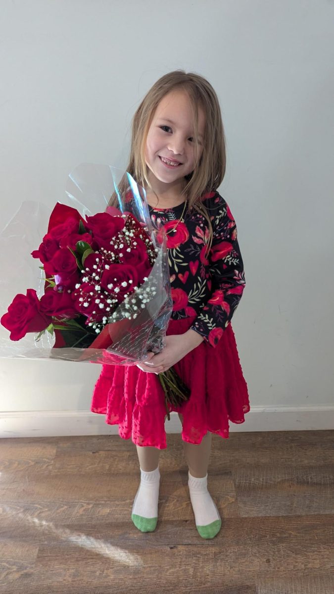 Fiona Norato clutches her bouquet of roses and smiles for the camera.