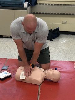 Mr. Mansfield demonstrates the proper technique for CPR.