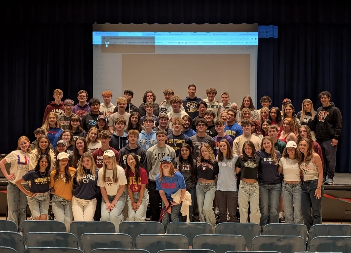Emerson's Class of 2025 posed for a picture with everyone in their college merchandise.